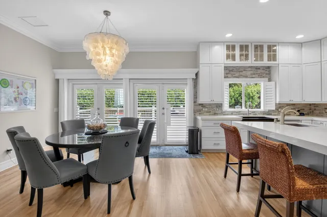 a view of a dining room with furniture wooden floor and chandelier