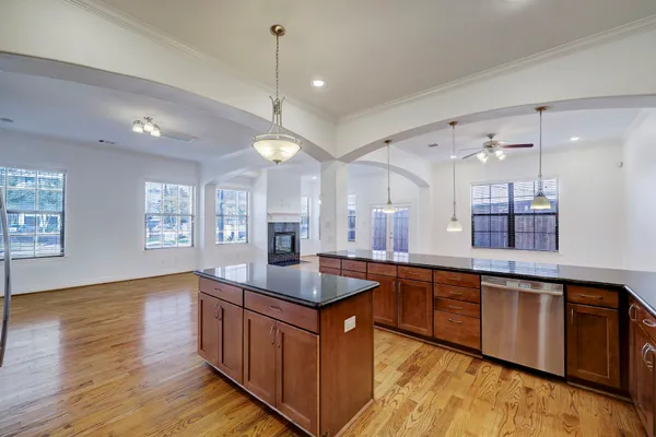 a kitchen with stainless steel appliances granite countertop wooden cabinets and sink
