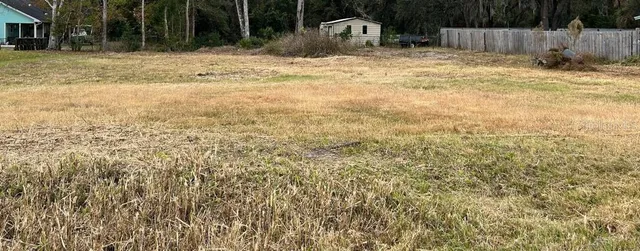 a backyard of a house with table and chairs