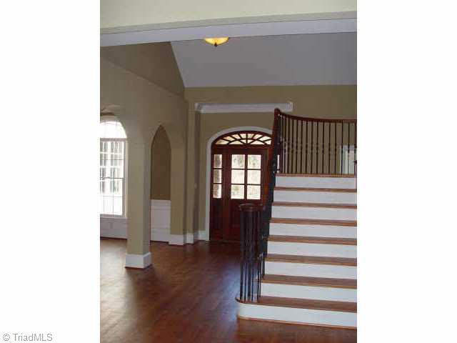 7017 Denison Road Summerfield, NC 27358 - Photo 7 of 9 Other. Spacious open foyer with a dramatic curved wrought iron staircase.