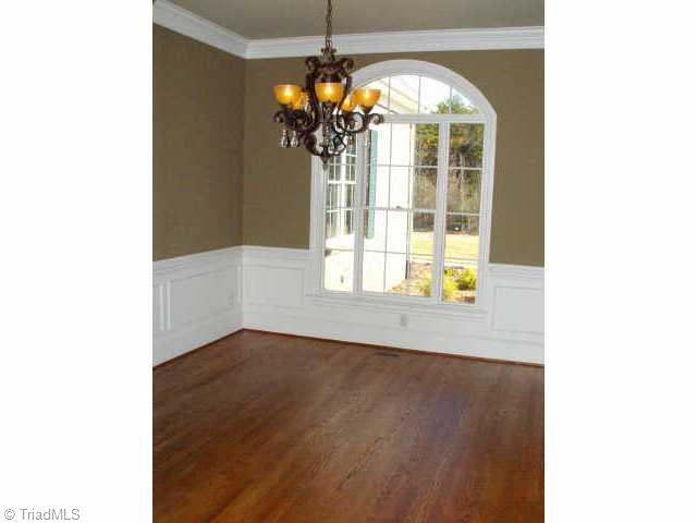 7017 Denison Road Summerfield, NC 27358 - Photo 8 of 9 Other. Gracious hardwood floored dining room with tray ceiling and designer light fixture.