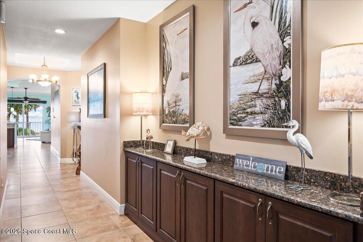 6005 Highway 1, Unit 101 Rockledge, FL 32955 - Photo 8 of 57 a kitchen with granite countertop a sink and a wooden cabinets