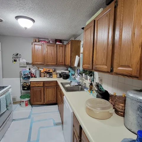 a kitchen with a sink stove and cabinets