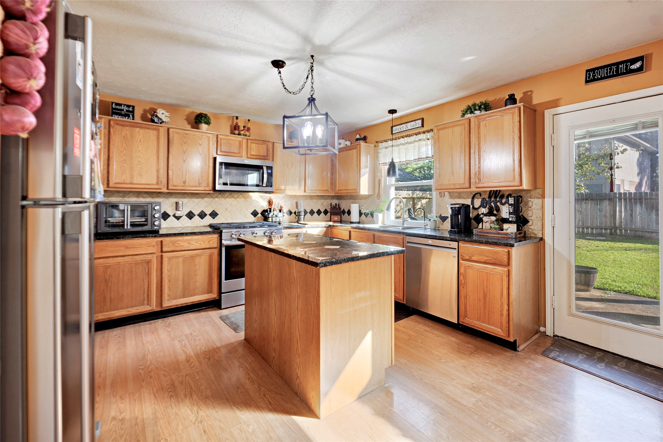a kitchen with stove a sink and refrigerator