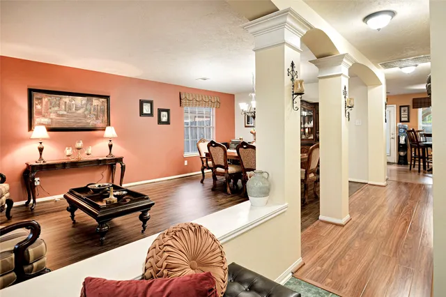 a living room with furniture and wooden floor