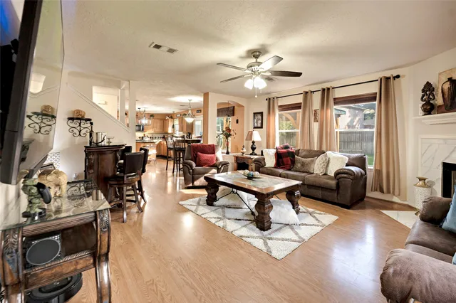 a living room with furniture a wooden floor and chandelier