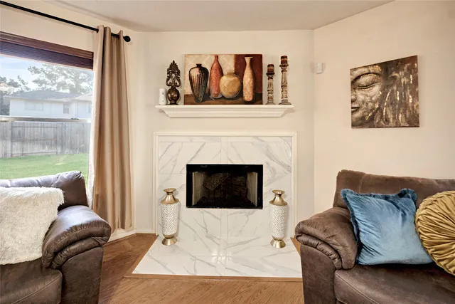 a living room with furniture and a fireplace