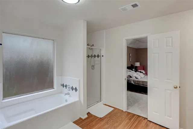 a bathroom with a bathtub and a shower