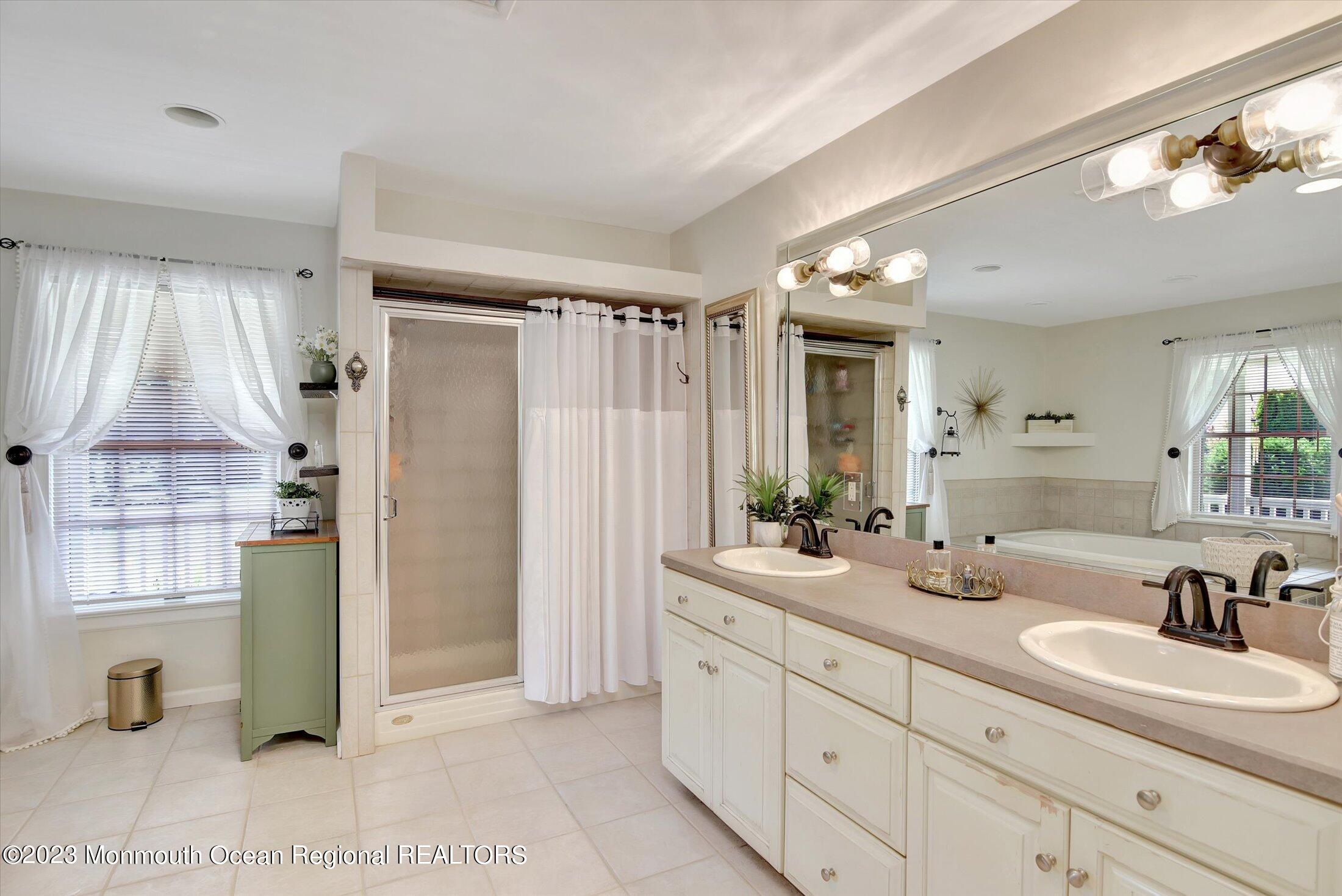535 Brickyard Road Freehold, NJ 07728 - Photo 13 of 52 a spacious bathroom with a double vanity sink mirror and shower