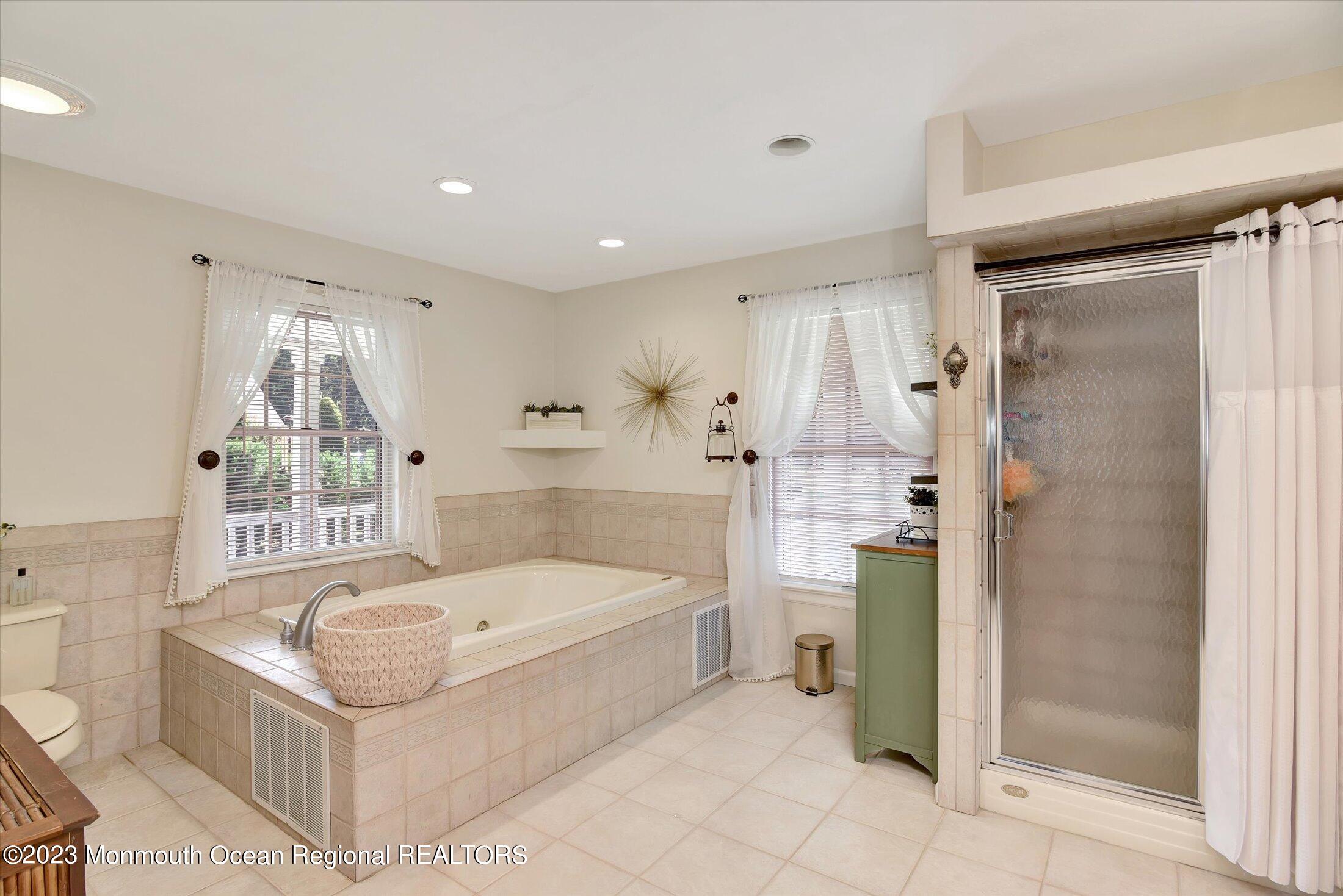 535 Brickyard Road Freehold, NJ 07728 - Photo 14 of 52 a white bath tub sitting in a bathroom