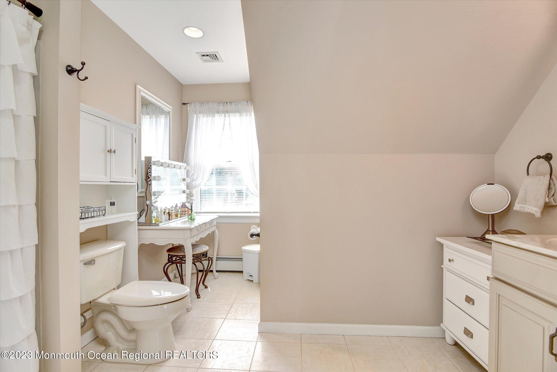 535 Brickyard Road Freehold, NJ 07728 - Photo 17 of 52 a bathroom with a sink toilet vanity and window