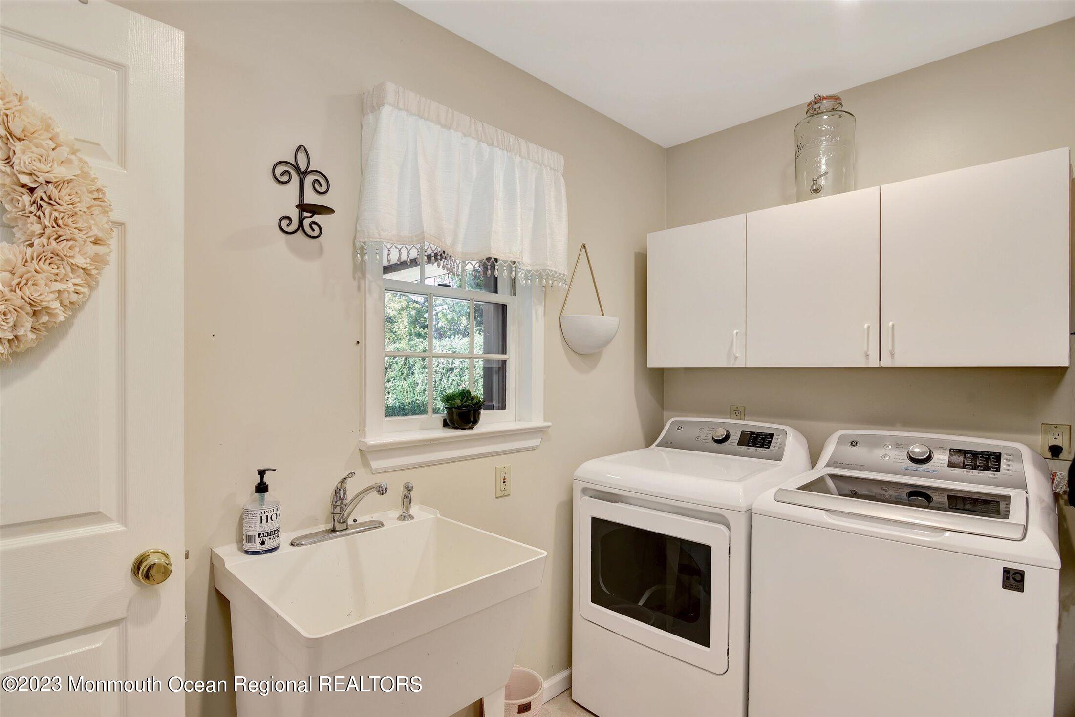535 Brickyard Road Freehold, NJ 07728 - Photo 18 of 52 a utility room with cabinets washer and dryer