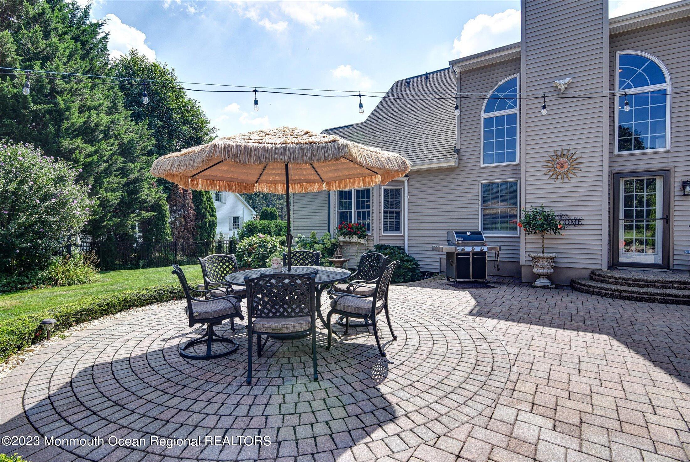 535 Brickyard Road Freehold, NJ 07728 - Photo 22 of 52 a patio with a patio table and chairs