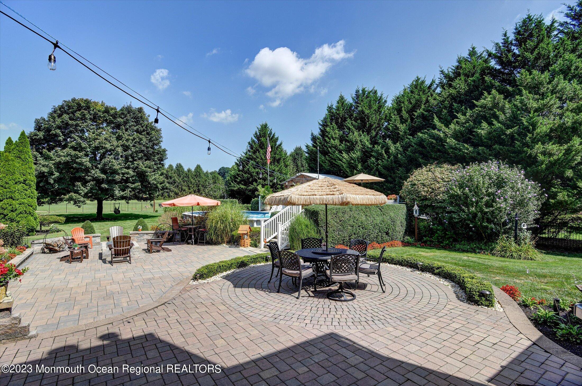 535 Brickyard Road Freehold, NJ 07728 - Photo 24 of 52 a view of a patio with furniture and a yard