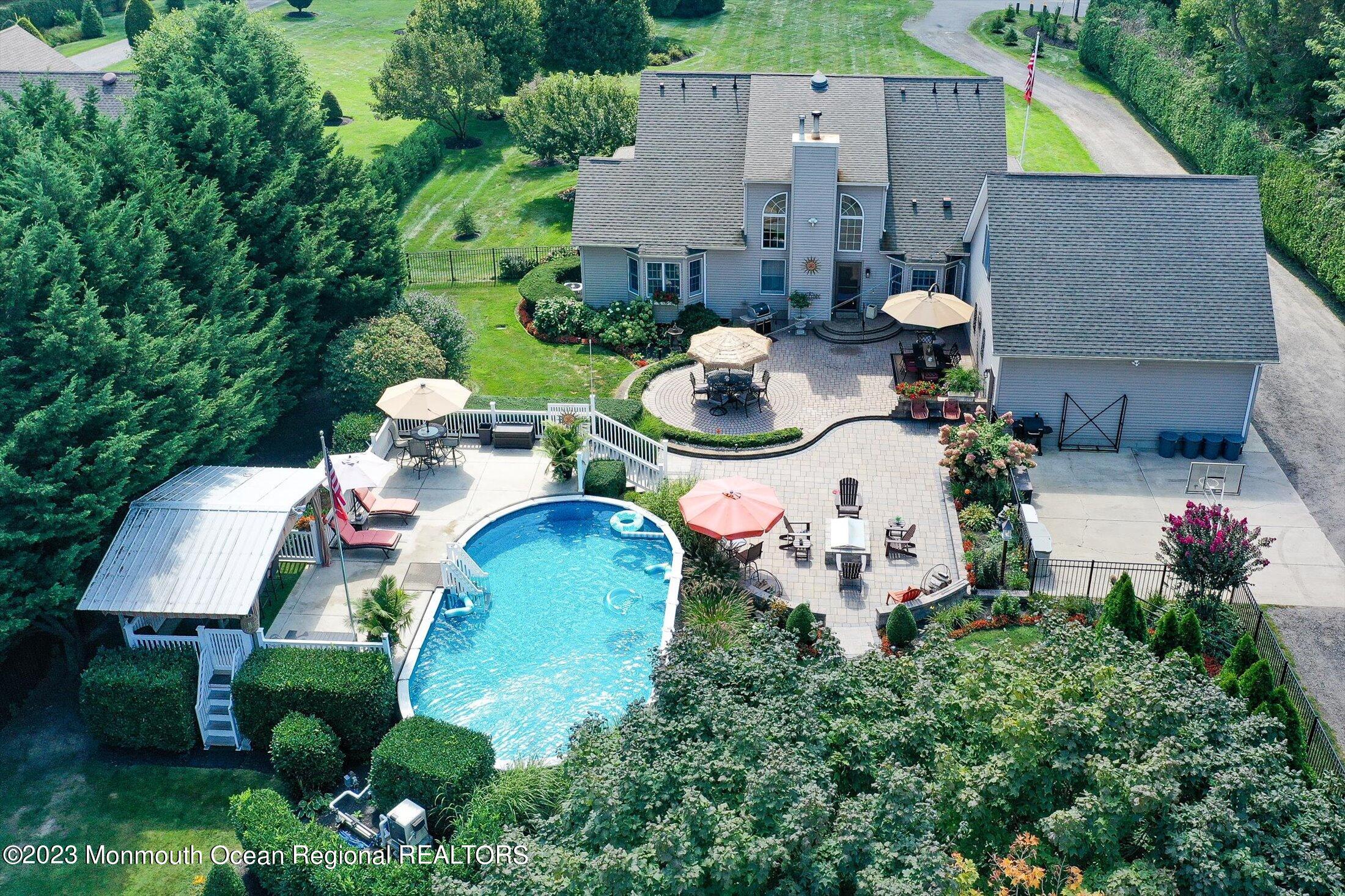 535 Brickyard Road Freehold, NJ 07728 - Photo 28 of 52 an aerial view of a house with yard and outdoor seating