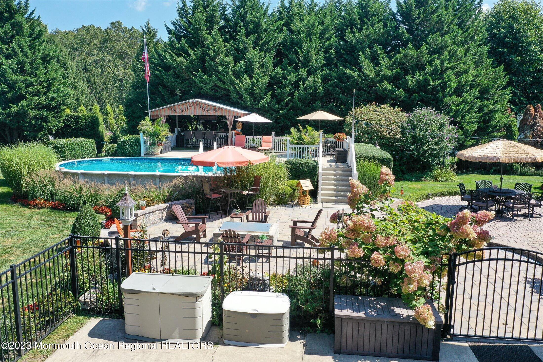 535 Brickyard Road Freehold, NJ 07728 - Photo 29 of 52 a view of a patio with furniture and a garden