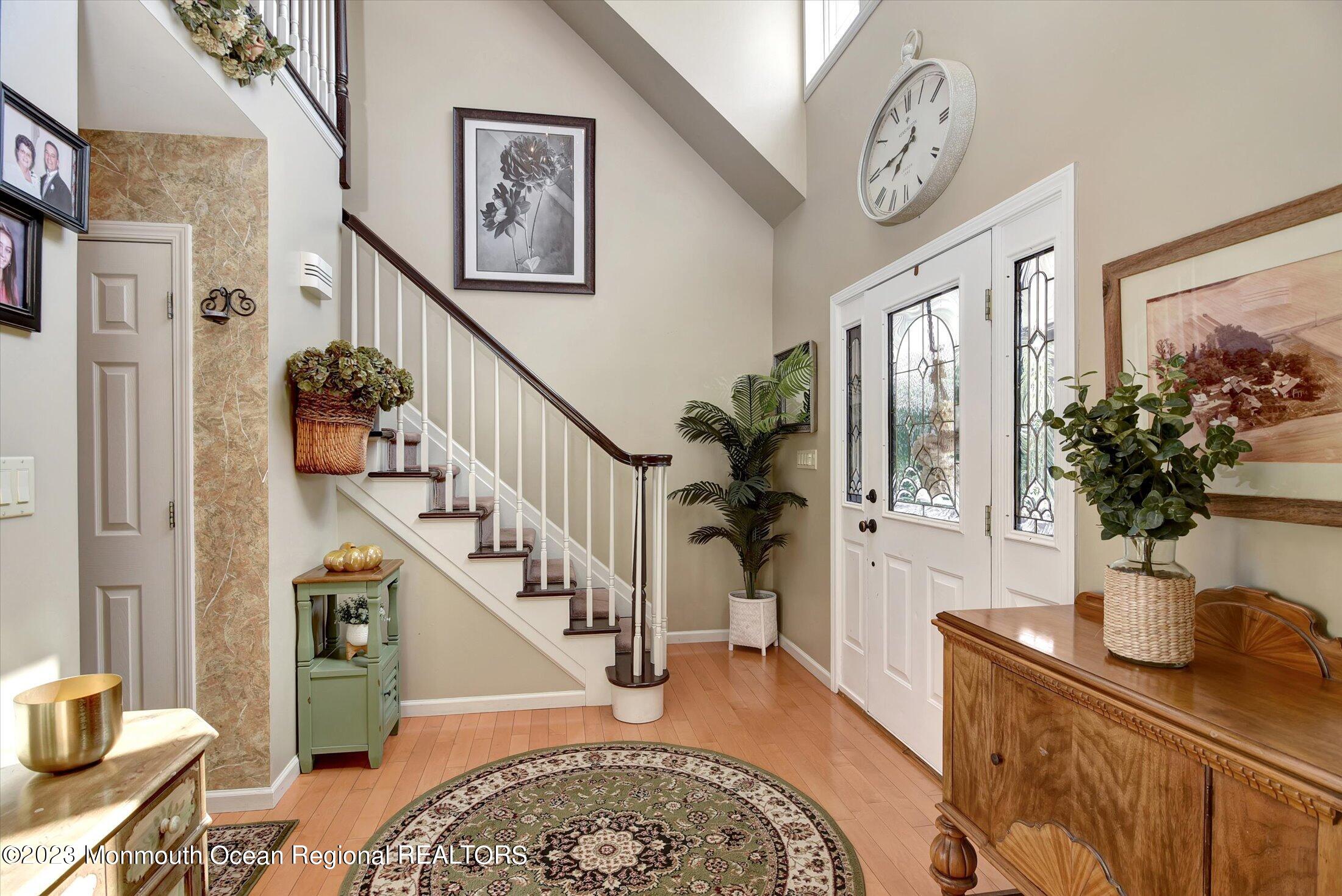 535 Brickyard Road Freehold, NJ 07728 - Photo 3 of 52 a living room with furniture stairs and a potted plant