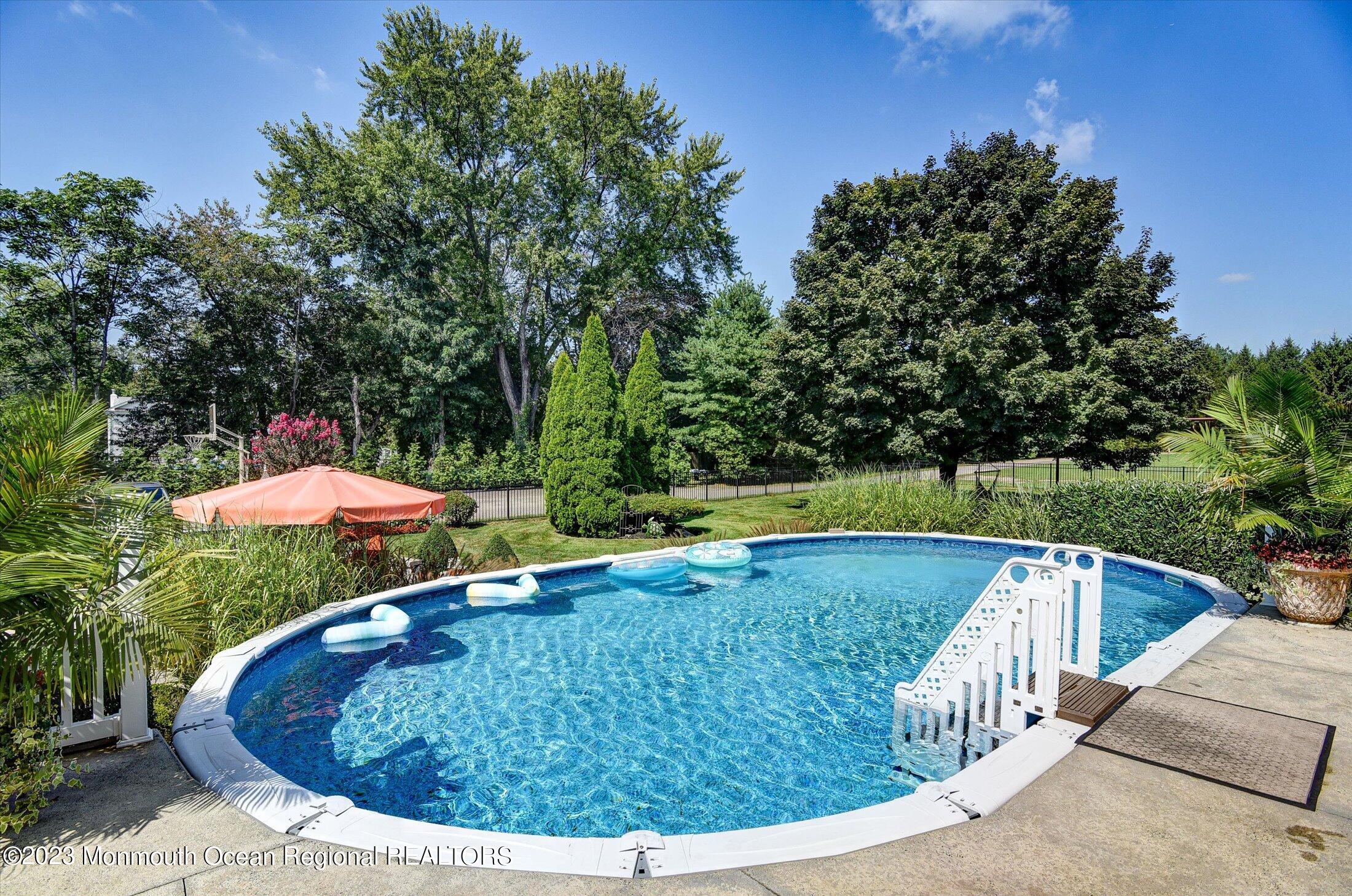 535 Brickyard Road Freehold, NJ 07728 - Photo 31 of 52 a view of a swimming pool with a yard and seating space