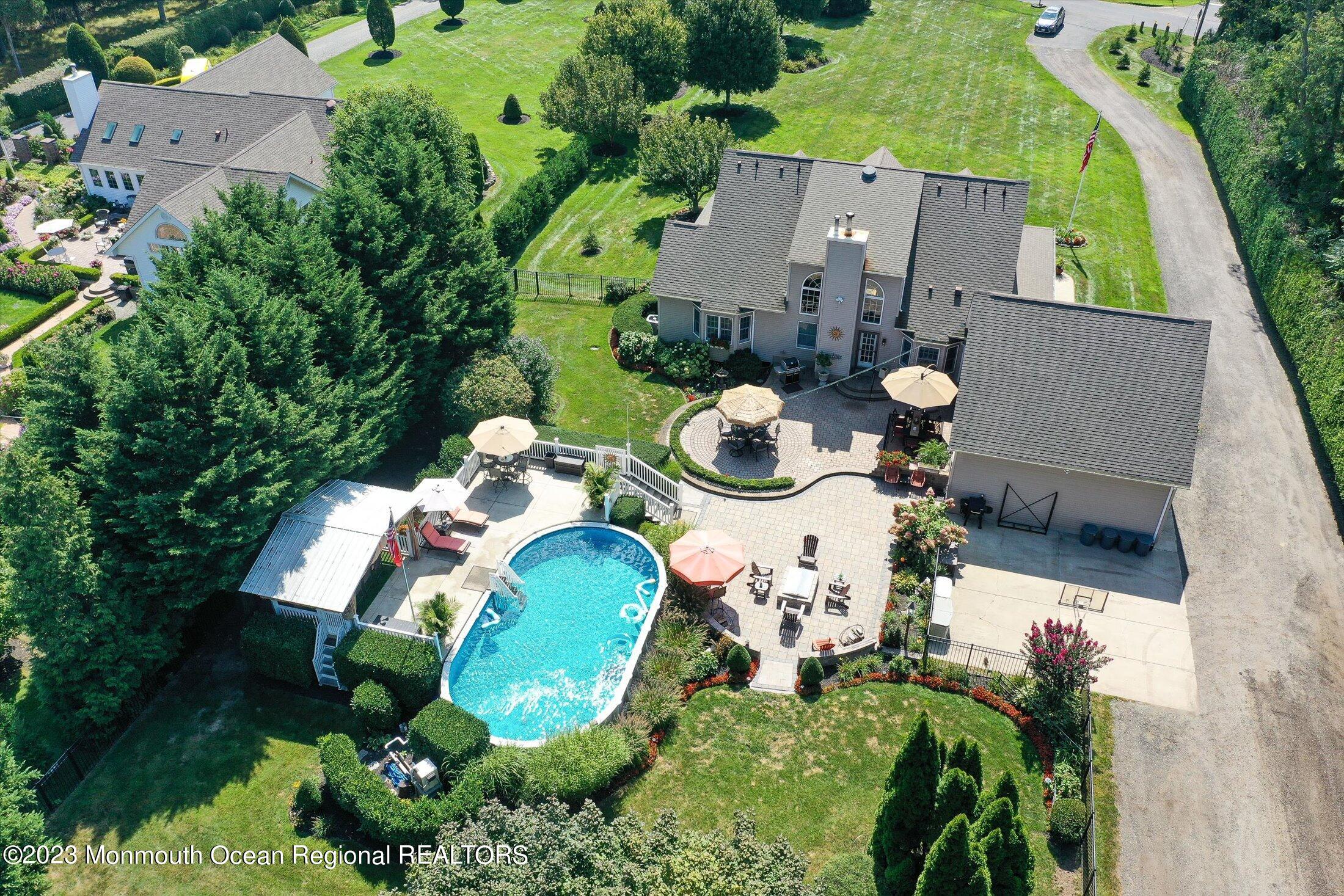 535 Brickyard Road Freehold, NJ 07728 - Photo 35 of 52 an aerial view of a house with a swimming pool a yard and lake view