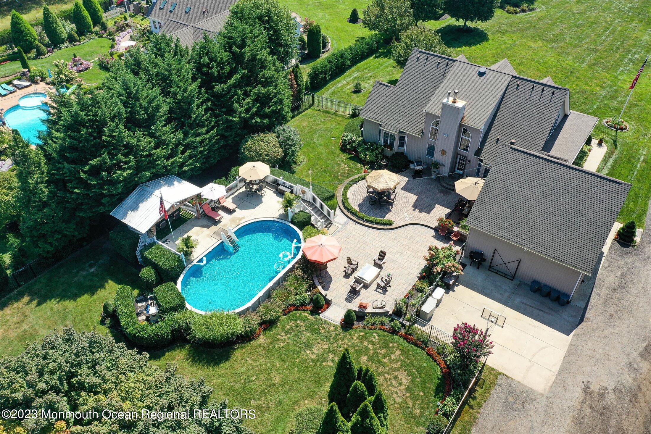 535 Brickyard Road Freehold, NJ 07728 - Photo 37 of 52 an aerial view of a house with yard swimming pool and outdoor seating