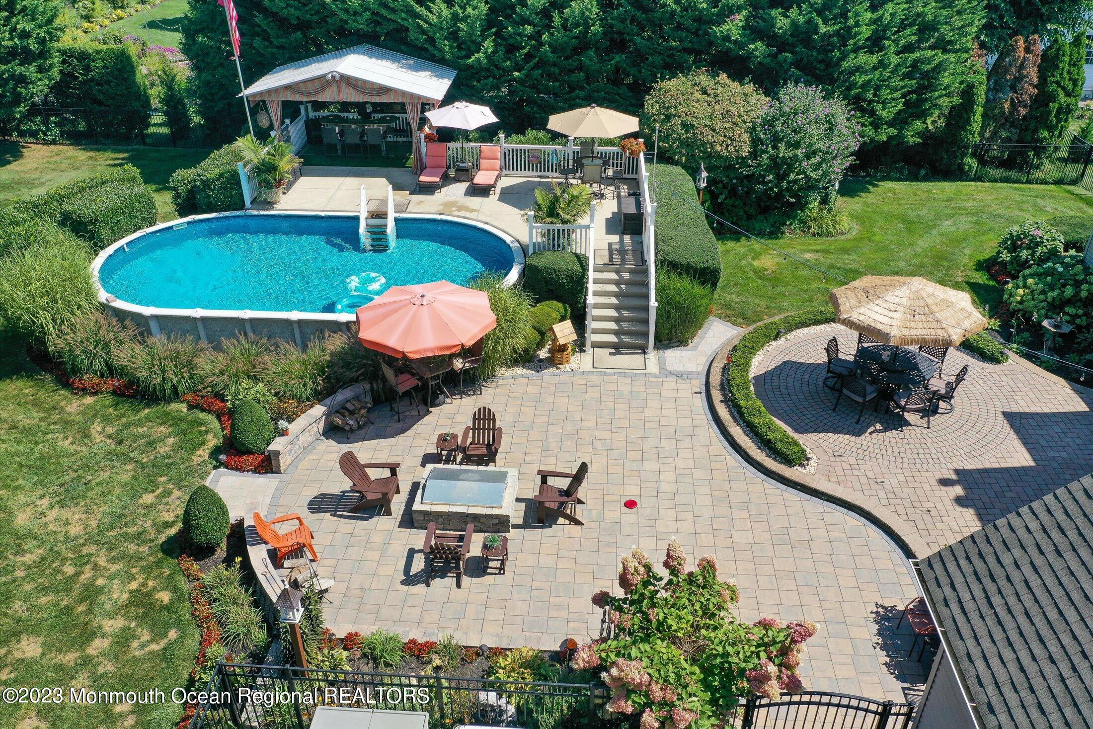 535 Brickyard Road Freehold, NJ 07728 - Photo 38 of 52 a view of a table and chairs in backyard