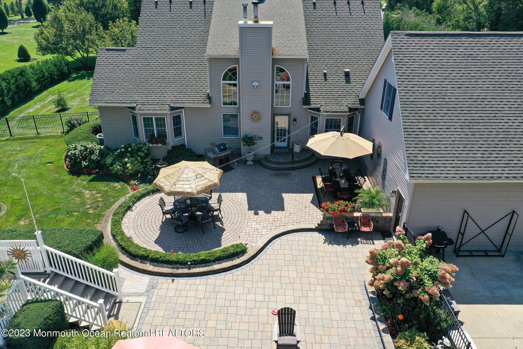 535 Brickyard Road Freehold, NJ 07728 - Photo 39 of 52 a backyard of a house with a fountain and outdoor seating
