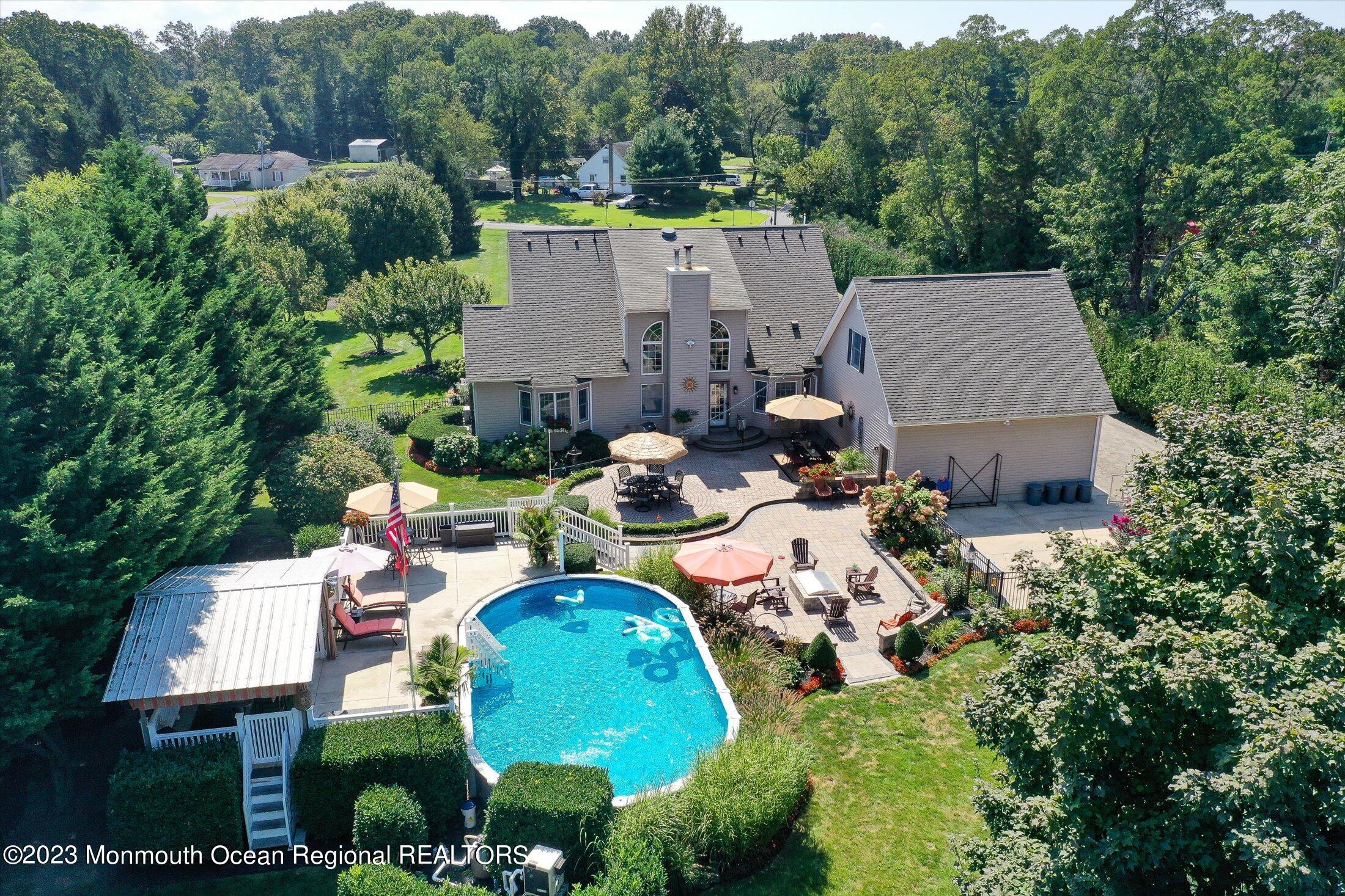 535 Brickyard Road Freehold, NJ 07728 - Photo 40 of 52 an aerial view of a house with swimming pool and outdoor seating