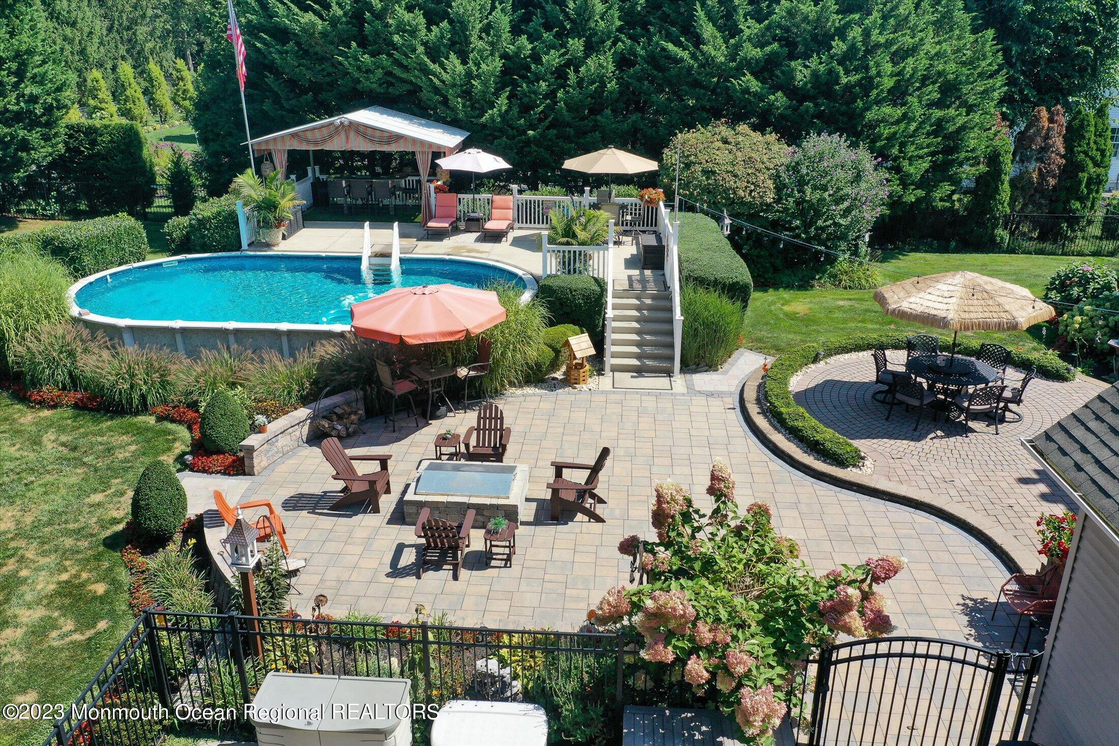 535 Brickyard Road Freehold, NJ 07728 - Photo 41 of 52 an outdoor space with furniture and umbrella