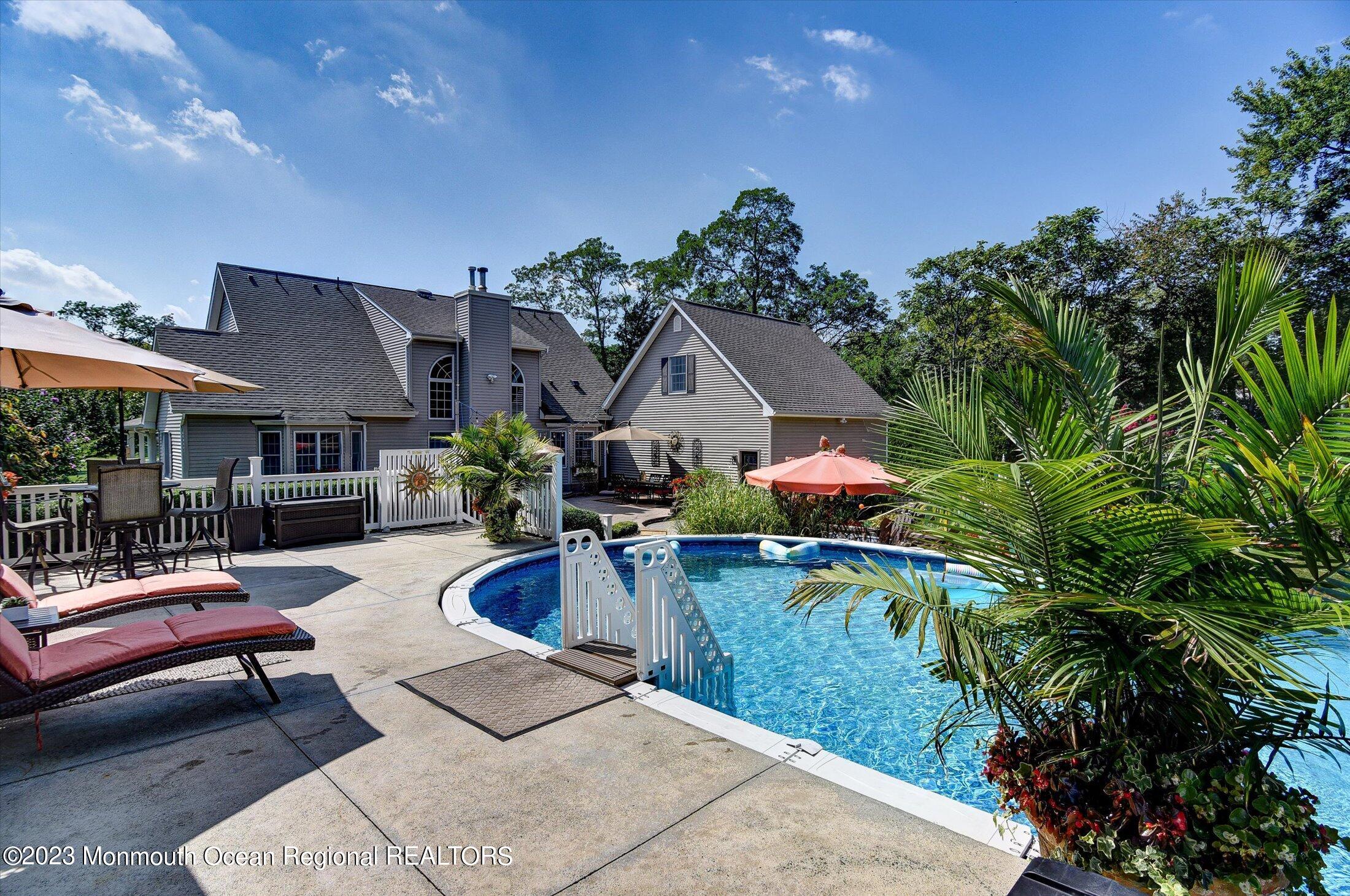 535 Brickyard Road Freehold, NJ 07728 - Photo 44 of 52 a view of a house with swimming pool and sitting area