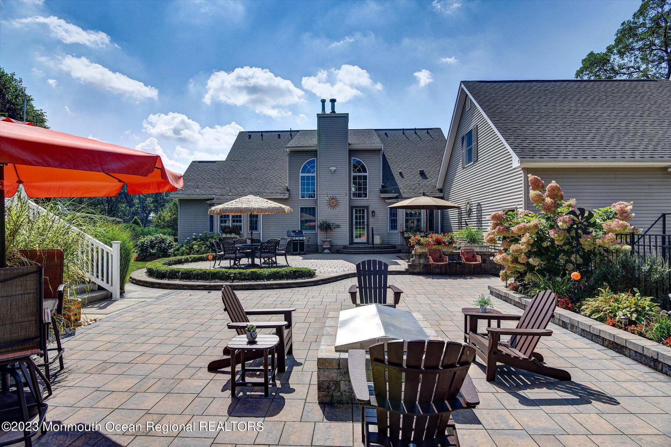 535 Brickyard Road Freehold, NJ 07728 - Photo 46 of 52 a view of a patio with dining table and chairs