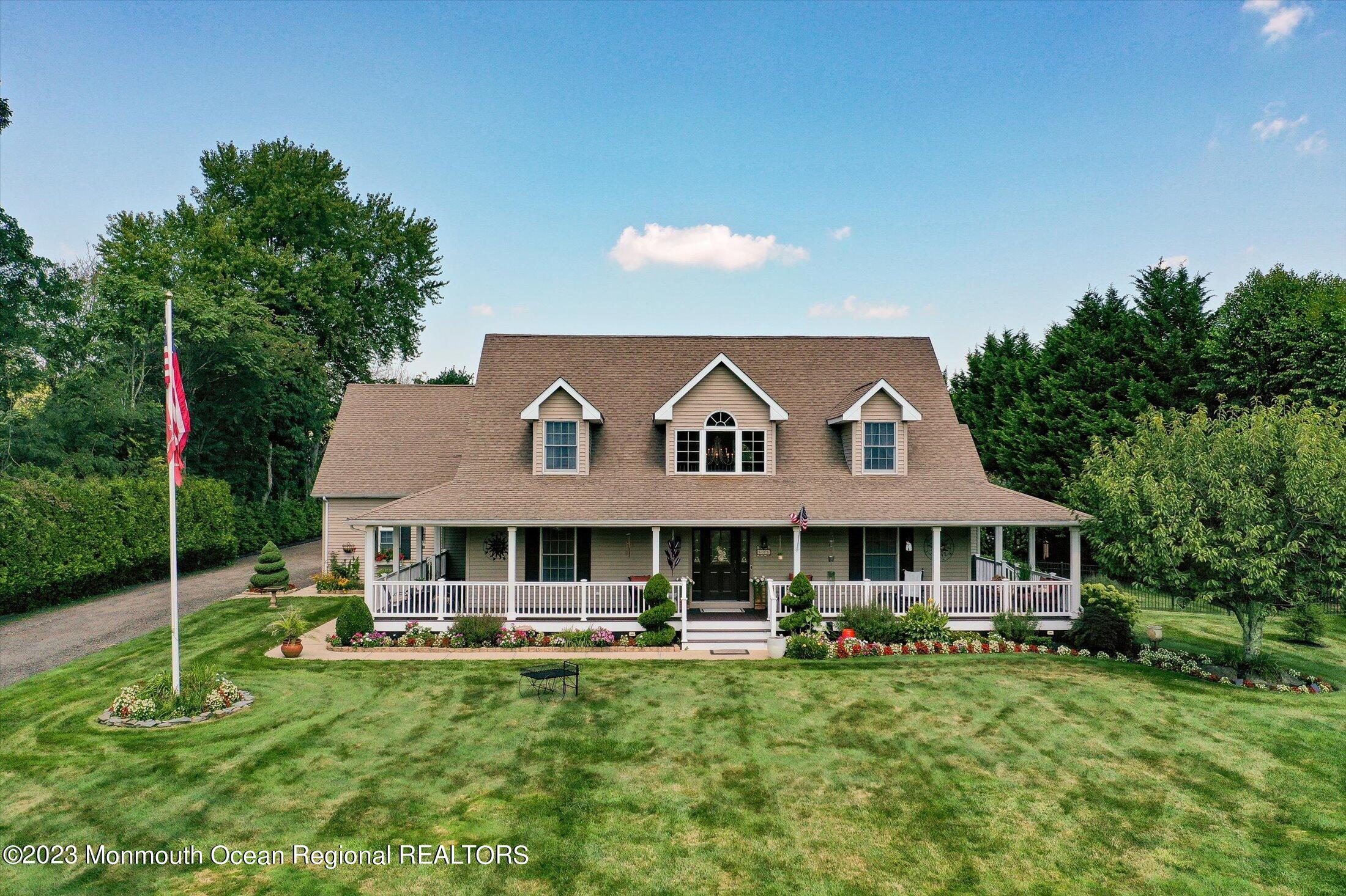 535 Brickyard Road Freehold, NJ 07728 - Photo 52 of 52 a front view of a house with a yard table and chairs