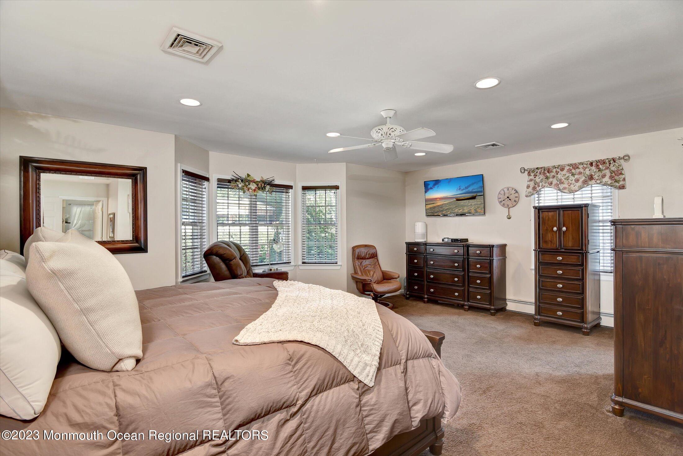 535 Brickyard Road Freehold, NJ 07728 - Photo 9 of 52 a large bedroom with bed and glass window