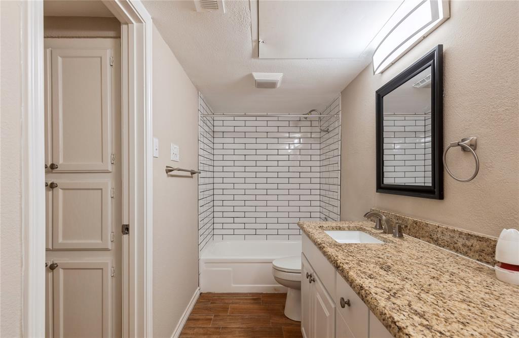 5750 Phoenix Drive, Unit 27 Dallas, TX 75231 - Photo 13 of 19 a bathroom with a granite countertop sink toilet and shower