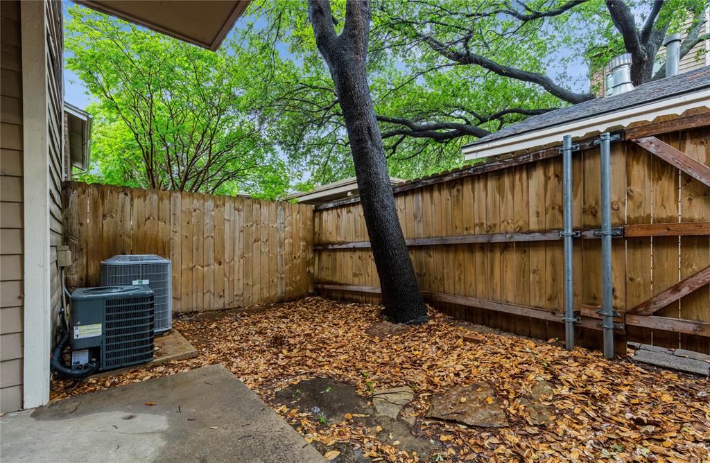 5750 Phoenix Drive, Unit 27 Dallas, TX 75231 - Photo 18 of 19 a backyard of a house with wooden floor barbeque oven and yard