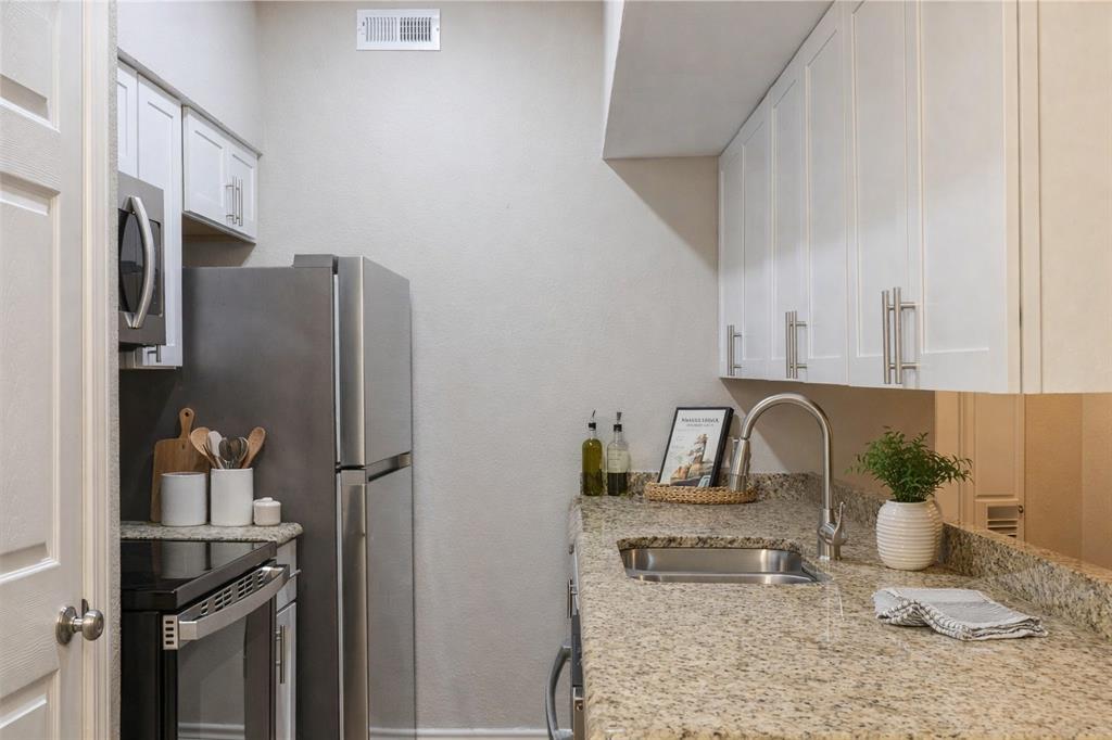 5750 Phoenix Drive, Unit 27 Dallas, TX 75231 - Photo 3 of 19 a kitchen with a refrigerator and a sink