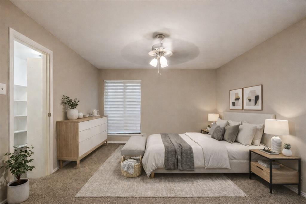 5750 Phoenix Drive, Unit 27 Dallas, TX 75231 - Photo 4 of 19 a spacious bedroom with a bed and a chandelier