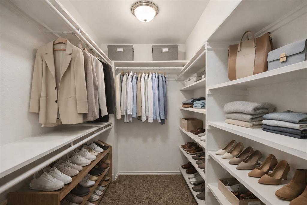 5750 Phoenix Drive, Unit 27 Dallas, TX 75231 - Photo 5 of 19 a view of walk in closet with clothes and shoes