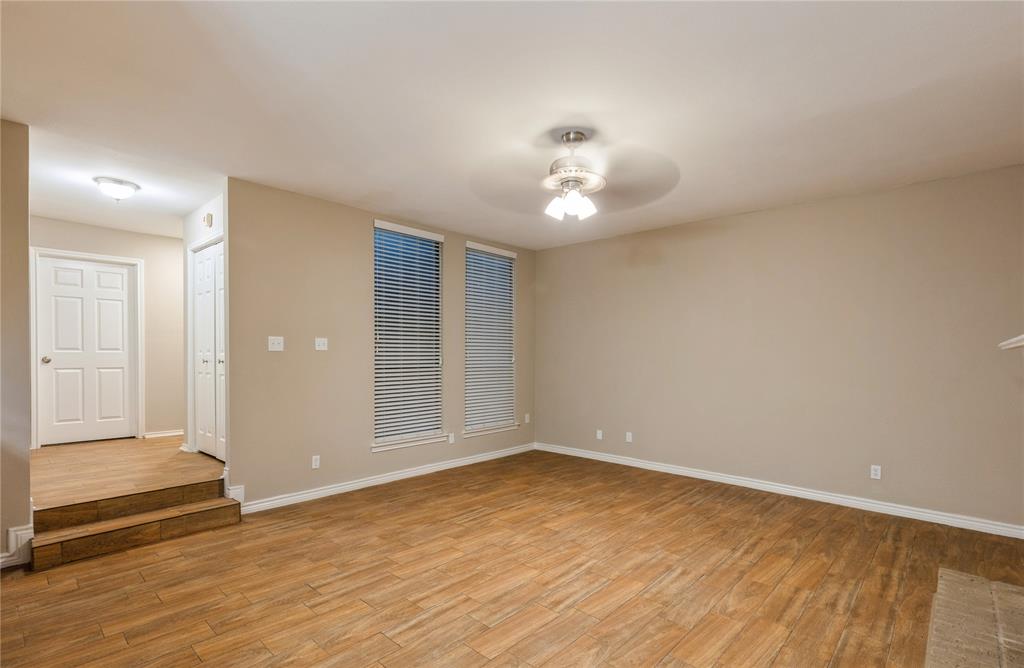 5750 Phoenix Drive, Unit 27 Dallas, TX 75231 - Photo 9 of 19 wooden floor in an empty room with a window