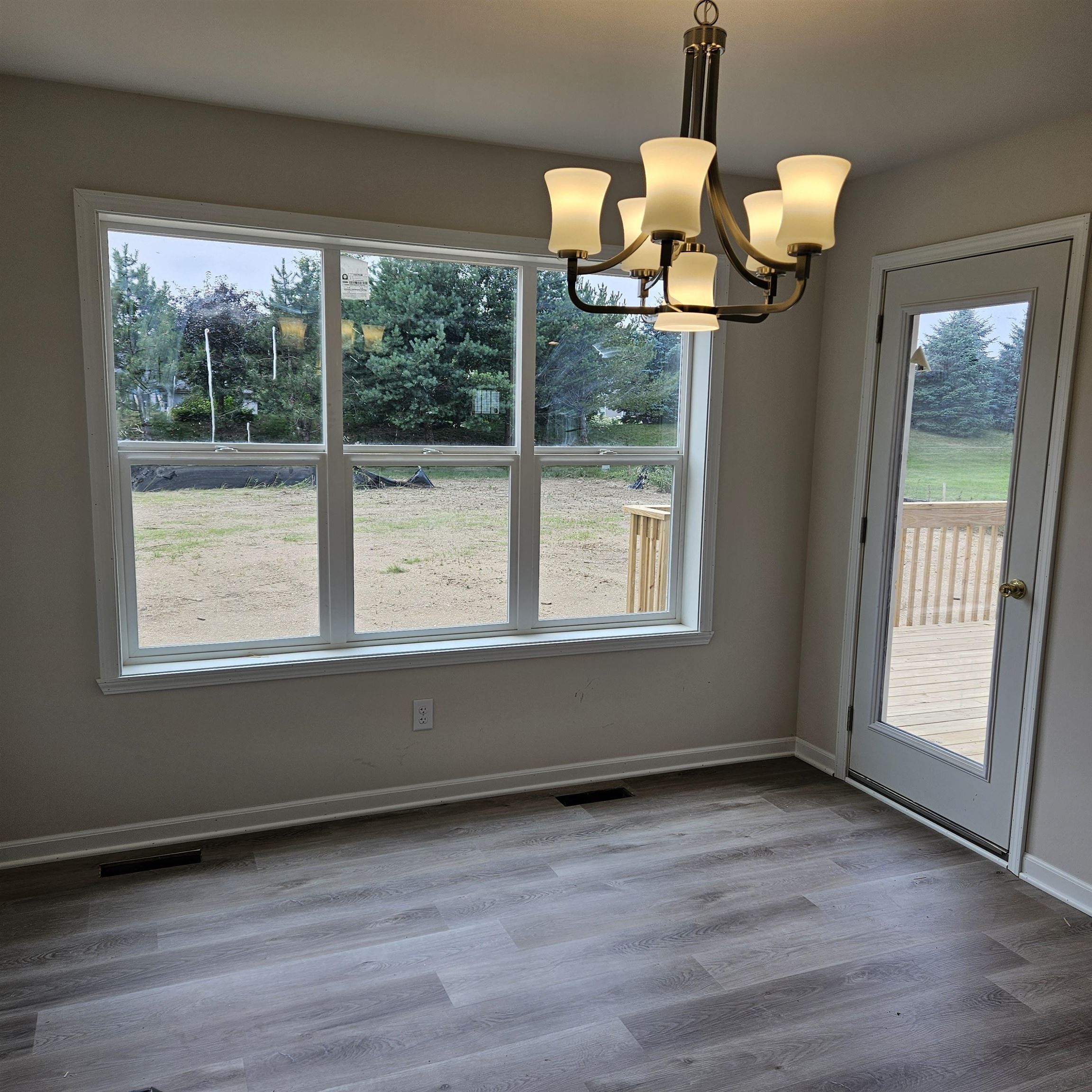 5552 Waters Bend Drive Belvidere, IL 61008 - Photo 5 of 12 a view of a room with wooden floor fan and window