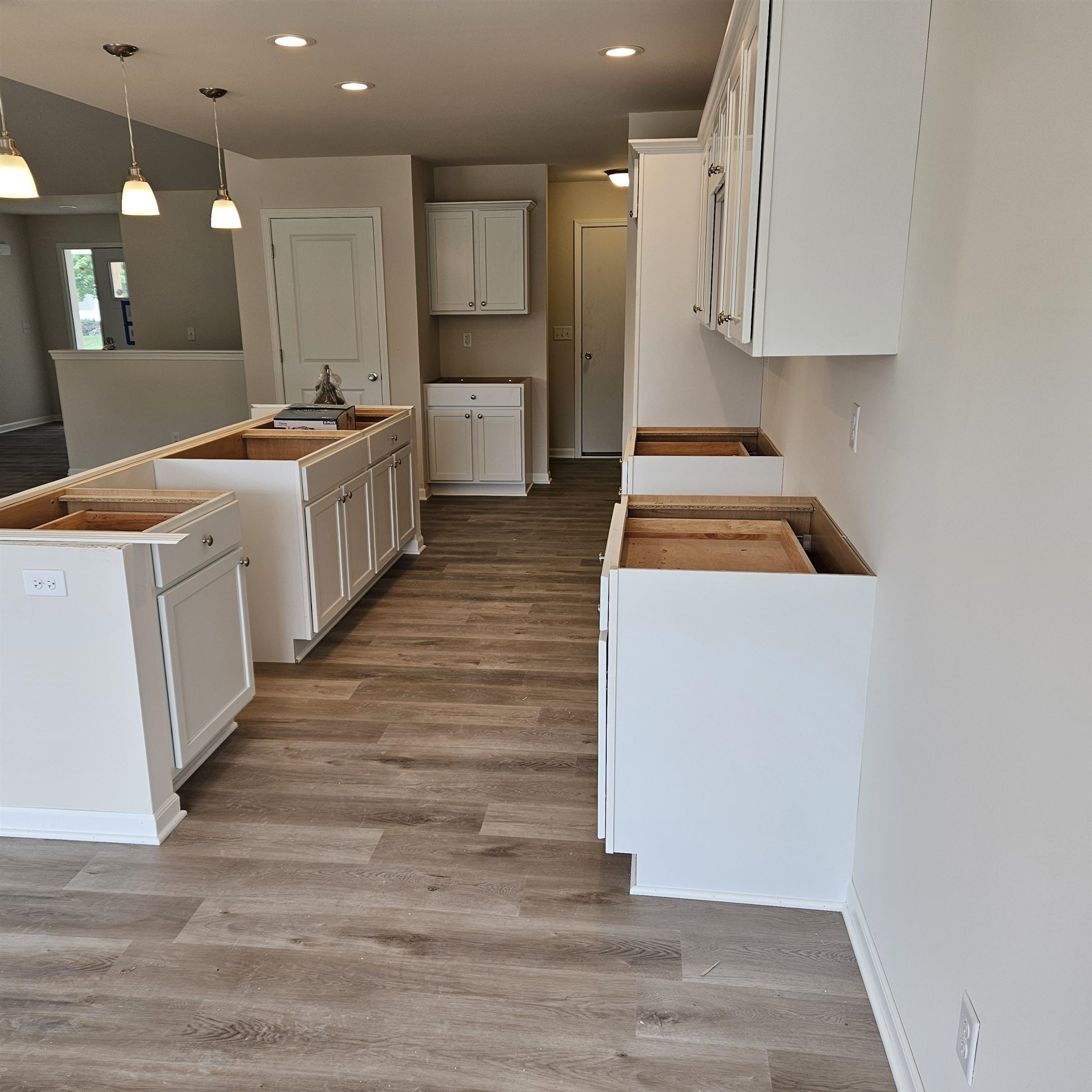 5552 Waters Bend Drive Belvidere, IL 61008 - Photo 6 of 12 a room with kitchen island a sink a stove and a refrigerator