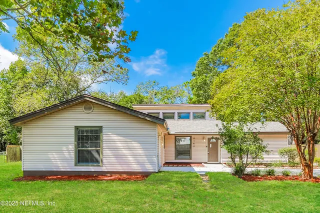 a front view of house with yard and green space