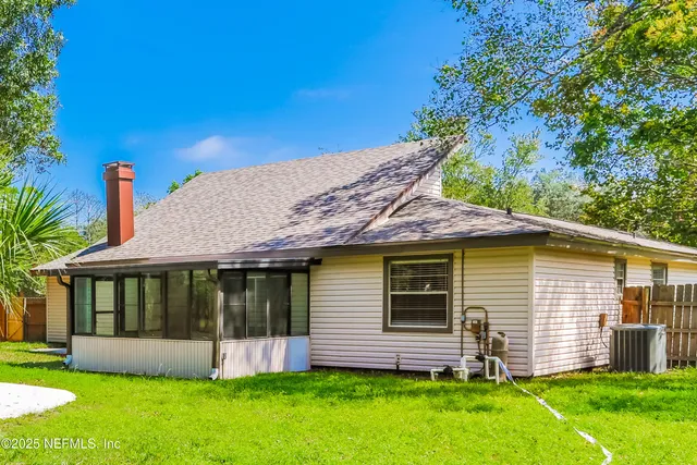 a front view of a house with a garden and yard