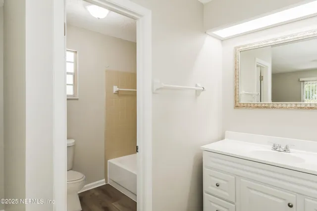 a bathroom with a sink a toilet a shower and a mirror