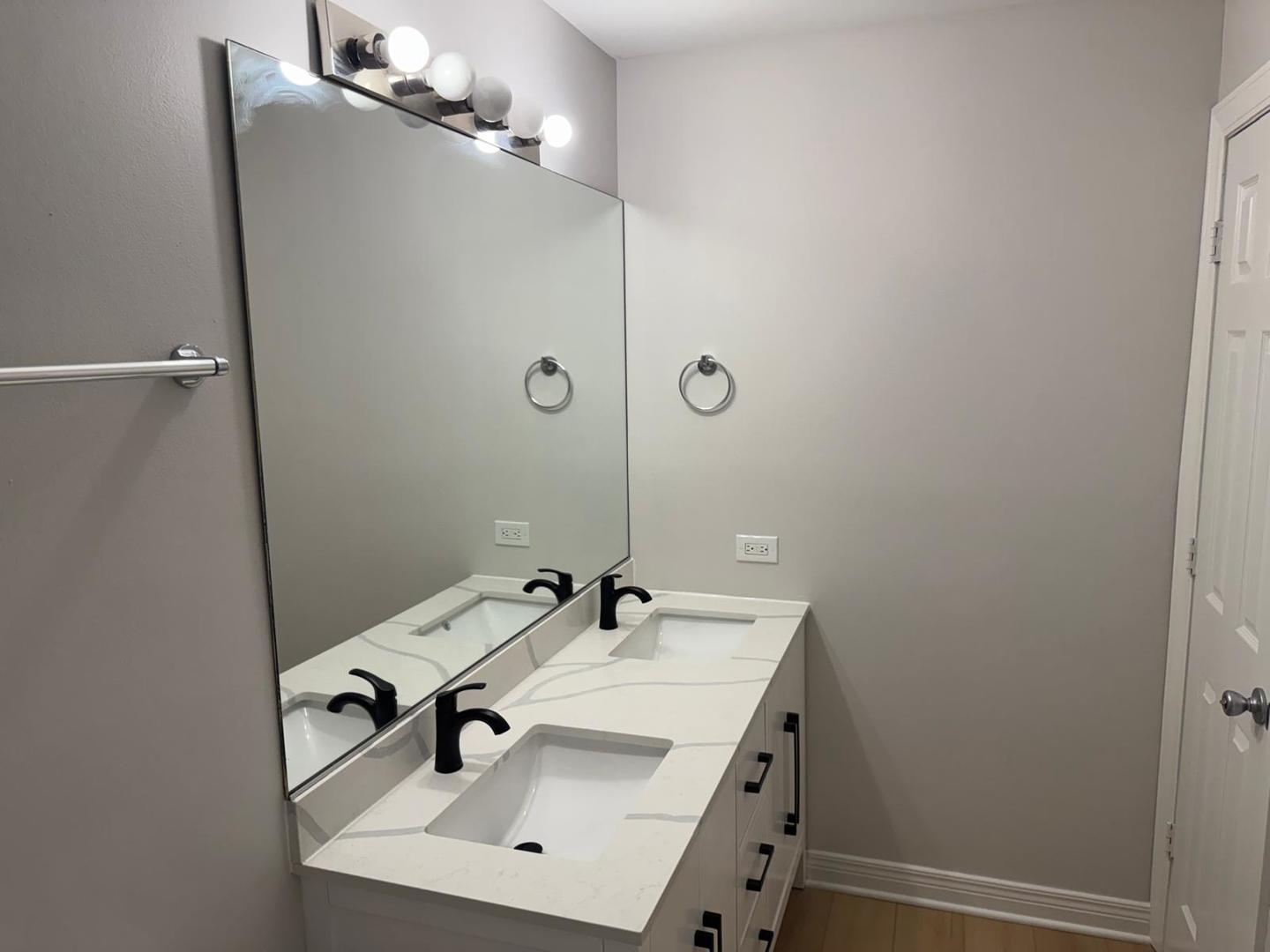1935 North Hicks Road, Unit 106 Palatine, IL 60074 - Photo 15 of 16 a bathroom with a sink and mirror