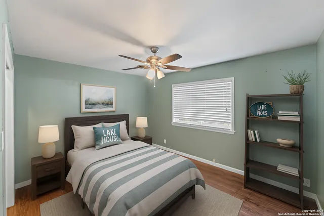 a view of a livingroom with a hardwood floor and a ceiling fan