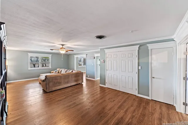 a spacious bedroom with a bed and a wooden floor