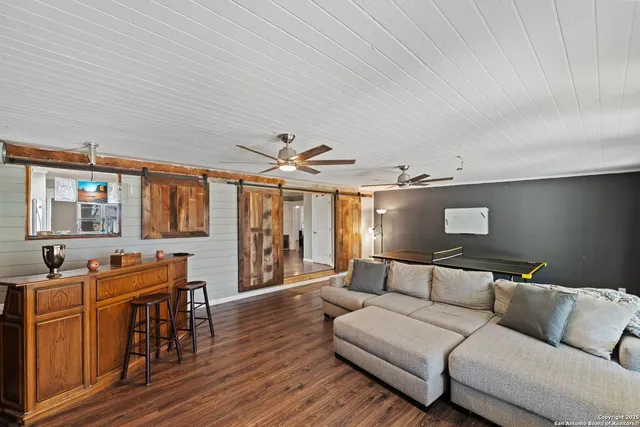 a living room with furniture and wooden floor