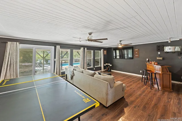 a living room with furniture and large windows