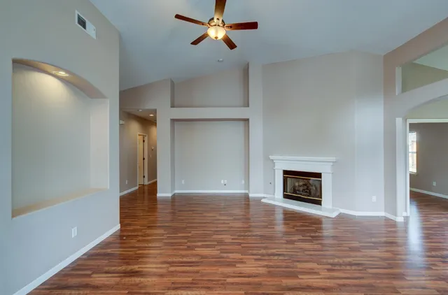 a view of empty room with wooden floor