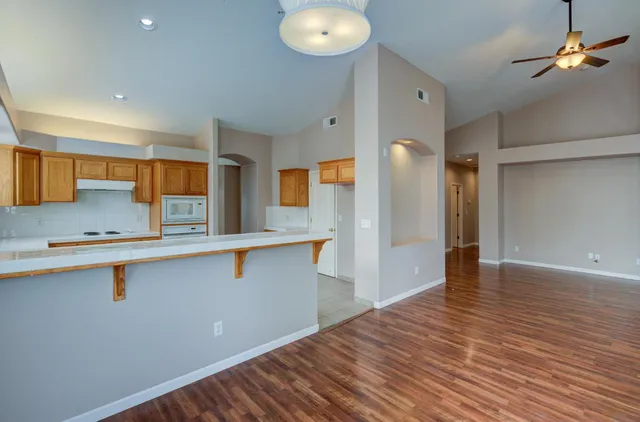 a view of a kitchen counter space and wooden floor